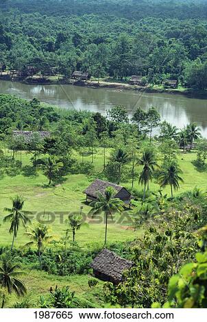Grass shacks along Kariwari River; Papua New Guinea View Large Photo Image Stock Photography - Grass shacks along Kariwari River; Papua New Guinea. Fotosearch