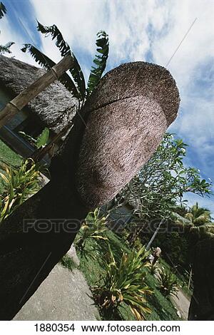 Picture - Grass Statue Infront Of Village. Fotosearch