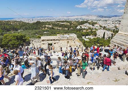 Stock Image - Greece, Athens, Tourists Walking Around The Historic Ruins Of The Parthenon.. Fotosearch