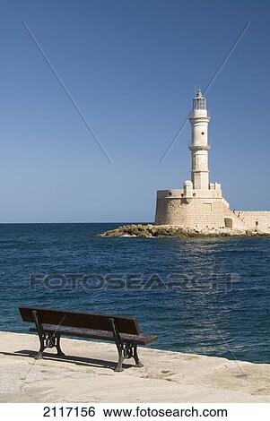 Greece, Crete, Hania, Architectural detail of a bench facing a lighthouse. View Large Photo Image Stock Photograph - Greece, Crete, Hania, Architectural detail of a bench facing a lighthouse.. Fotosearch
