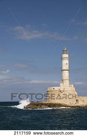 Stock Photo - Greece, Crete, Hania, Wave crashing on a lighthouse.. Fotosearch