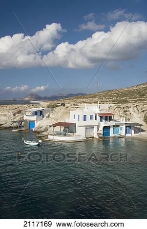 Greece, Cyclades, Island of Milos, Village of Mitakas, boats and houses near shore. View Large Photo Image Stock Photo - Greece, Cyclades, Island of Milos, Village of Mitakas, boats and houses near shore.. Fotosearch