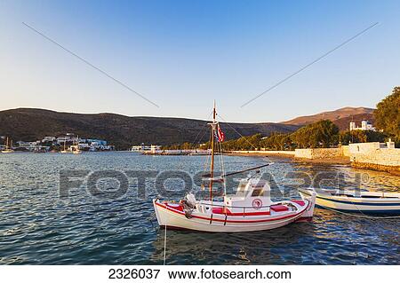 Stock Photo - Greece, Greek Islands, Fishing Boat, Classic Mountain Town In Distance.. Fotosearch