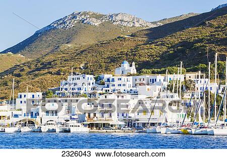 Stock Image - Greece, Greek Islands, White Beach And Tropical Setting, Boats In Harbor.. Fotosearch