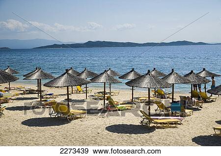 Greece, Halkidiki, Beach umbrellas and chairs on tourist beach; Ouranoupoli View Large Photo Image Stock Photo - Greece, Halkidiki, Beach umbrellas and chairs on tourist beach; Ouranoupoli. Fotosearch