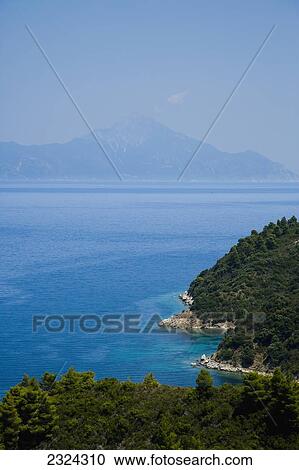 Greece, Halkidiki, Forested coastline with Mount Athos visible in distance; Sithonia View Large Photo Image Stock Image - Greece, Halkidiki, Forested coastline with Mount Athos visible in distance; Sithonia. Fotosearch