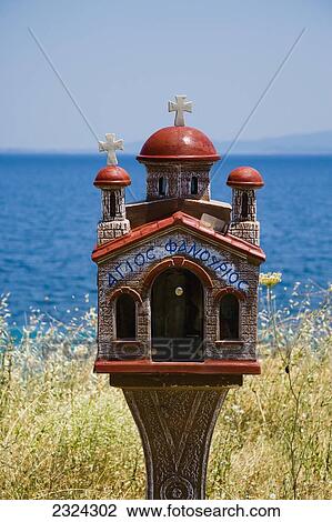 Stock Image - Greece, Halkidiki, Miniature church shrine overlooking Mediterranean sea; Sithonia. Fotosearch