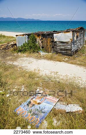 Greece, Halkidiki, next to a dilapidated old shed/ shack; Ierissos, laid on the beach, Fallen down sign for an exotic looking Beach club View Large Photo Image Stock Image - Greece, Halkidiki, next to a dilapidated old shed/ shack; Ierissos, laid on the beach, Fallen down sign for an exotic looking Beach club. Fotosearch