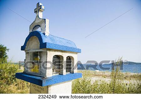 Greece, Halkidiki, Shrine along coast road with Meditarrenean sea visible in distance; Ouranoupoli View Large Photo Image Stock Photo - Greece, Halkidiki, Shrine along coast road with Meditarrenean sea visible in distance; Ouranoupoli. Fotosearch