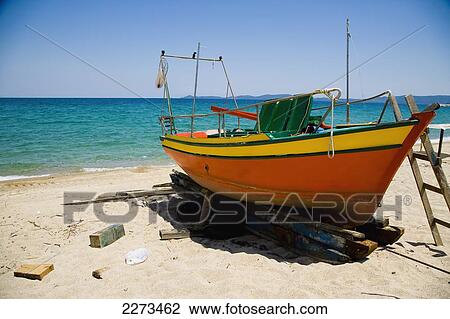 Stock Image - Greece, Halkidiki, Small fishing boats in various stages or repair/ build on the beach outside some boat building premises; Ierissos. Fotosearch