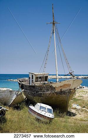 Greece, Halkidiki, Small fishing boats in various stages or repair/ build on the beach outside some boat building premises; Ierissos View Large Photo Image Stock Photo - Greece, Halkidiki, Small fishing boats in various stages or repair/ build on the beach outside some boat building premises; Ierissos. Fotosearch