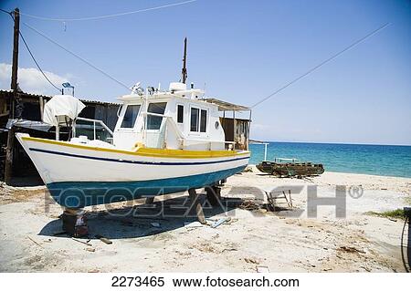 Stock Photography - Greece, Halkidiki, Small fishing boats in various stages or repair/ build on the beach outside some boat building premises; Ierissos. Fotosearch