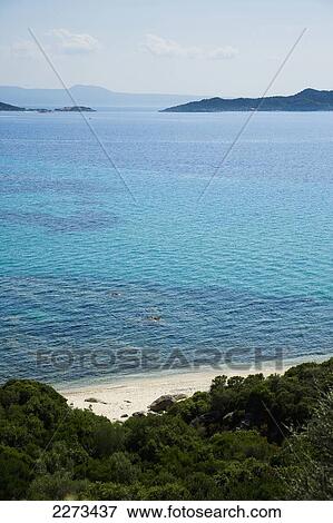 Greece, Halkidiki, Small secluded beach on the Mediterranean sea with the island of Ammouliani visible in the distance; Ouranoupoli View Large Photo Image Stock Photo - Greece, Halkidiki, Small secluded beach on the Mediterranean sea with the island of Ammouliani visible in the distance; Ouranoupoli. Fotosearch
