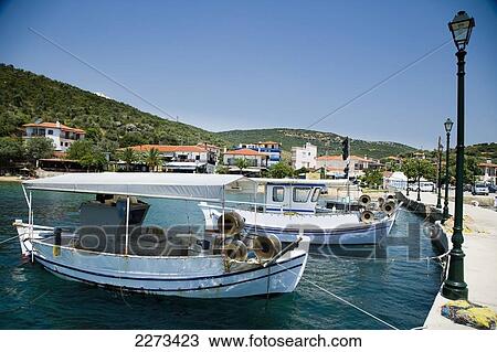 Greece, Halkidiki, Traditional wooden fishing boats moored in small harbor at seaside town; Pirgadikia View Large Photo Image Stock Image - Greece, Halkidiki, Traditional wooden fishing boats moored in small harbor at seaside town; Pirgadikia. Fotosearch