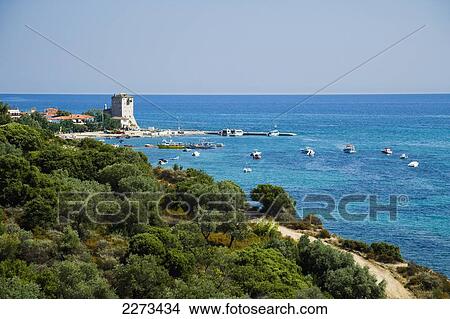 Picture - Greece, Halkidiki, View from the roadside with the Byzantine Tower or Tower of Prosforios in the distance; Ouranoupoli. Fotosearch