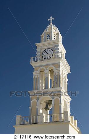 Stock Photograph - Greece, Santorini, Fira, Architectural detail of a Catholic Cathedral Chrurch bell and clock tower.. Fotosearch