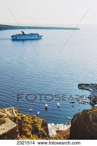 Picture - Greece, Santorini, Large Ship Sailing Into The Santorini Caldera At Sunset.. Fotosearch