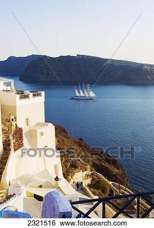 Stock Photograph - Greece, Santorini, Large Ship Sailing Into The Santorini Caldera At Sunset.. Fotosearch