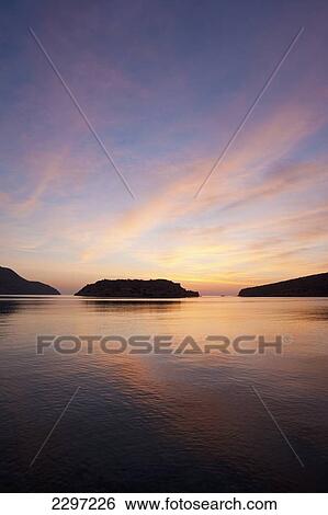 Stock Photograph - Greece, Silhouette of island of Spinalonga at dawn; Crete. Fotosearch
