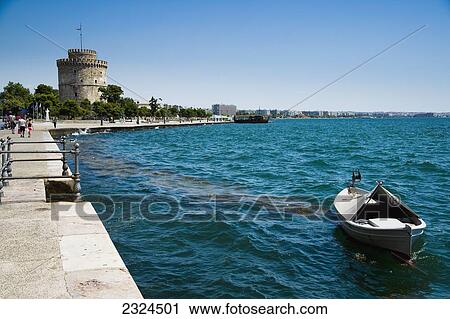 Stock Image - Greece, Small fishing boat and White Tower; Thessaloniki. Fotosearch