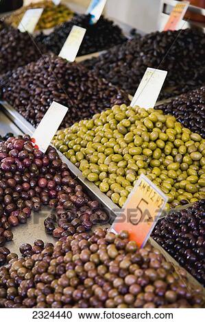 Stock Image - Greece, Variety of Greek olives for sale at market stall; Thessaloniki. Fotosearch