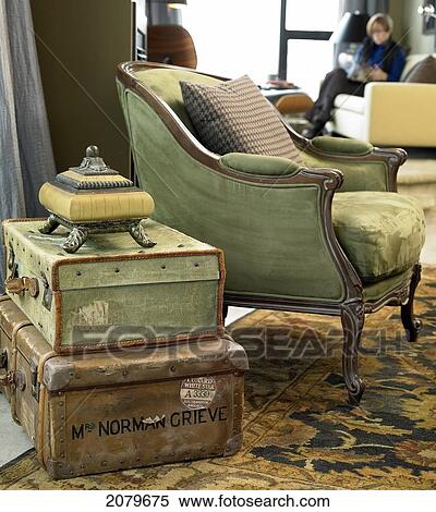 Green Arm Chair With 2 Leather Suitcases Stacked As Side Table, Victoria Bc. View Large Photo Image Stock Photography - Green Arm Chair With 2 Leather Suitcases Stacked As Side Table, Victoria Bc.. Fotosearch