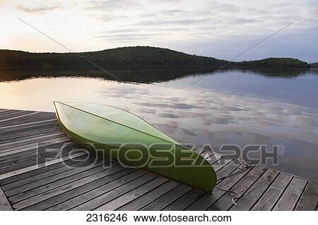 Stock Photograph - Green Canoe On A Cottage Dock In Algonquin Park; Ontario Canada. Fotosearch