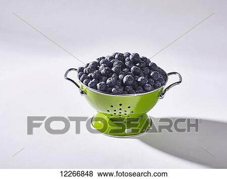 Green colander filled with fresh blueberries View Large Photo Image Stock Photo - Green colander filled with fresh blueberries. Fotosearch