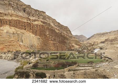 Stock Image - Green Fields And View Of Kali Gandaki Valley And Gorge; Chhsuang (Chuksang), Upper Mustang Valley, Nepal. Fotosearch