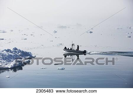 Stock Image - Greenland, Icefjord; Ilulissat (Jakobshavn), Unesco World Heritage Site, Fishermen going out to sea. Fotosearch