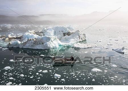 Stock Image - Greenland, Icefjord; Ilulissat, Fishermen going out to sea at Unesco World Heritage Site. Fotosearch