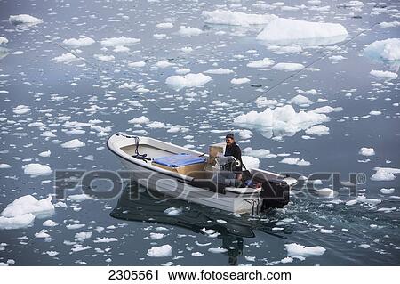 Stock Image - Greenland, Icefjord; Ilulissat, Fishermen going out to sea at Unesco World Heritage Site. Fotosearch