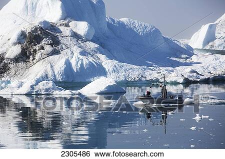 Stock Photograph - Greenland, Icefjord; Ilulissat (Jakobshavn), Unesco World Heritage Site, Fishermen going out to sea. Fotosearch