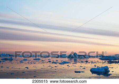 Stock Photography - Greenland, Icefjord; Ilulissat (Jakobshavn), Unesco World Heritage Site, The shoreline at sunset. Fotosearch
