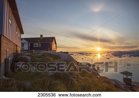 Stock Photograph - Greenland, Unesco World Heritage Site; Ilulissat, Colorful houses and icefjord. Fotosearch