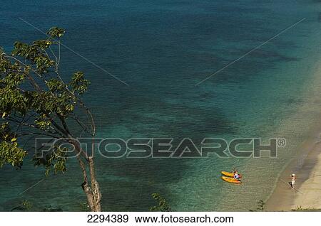 Stock Photo - Grenada, Kayaking off Magazine Beach viewed from Maca Bana Hotel and Villa complex; Caribbean. Fotosearch