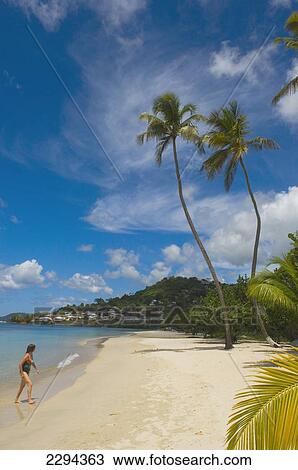 Stock Image - Grenada, Woman at Grand Anse Beach; Caribbean. Fotosearch