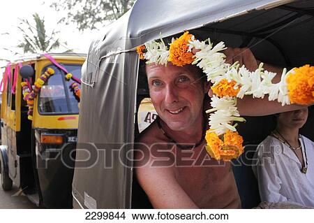 Groom takes a rickshaw taxi decorated with garlands of flowers, Patnum, Goa, India. View Large Photo Image Picture - Groom takes a rickshaw taxi decorated with garlands of flowers, Patnum, Goa, India.. Fotosearch