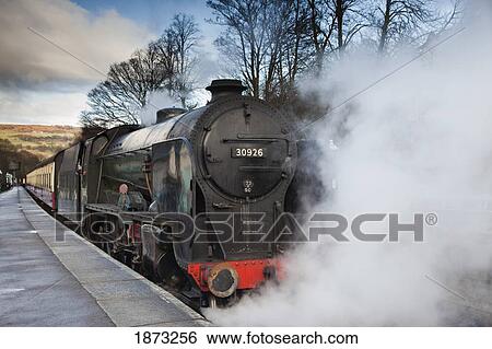 Grosmont, North Yorkshire, England; Steam From A Train Along The Tracks At A Station View Large Photo Image Stock Photograph - Grosmont, North Yorkshire, England; Steam From A Train Along The Tracks At A Station. Fotosearch