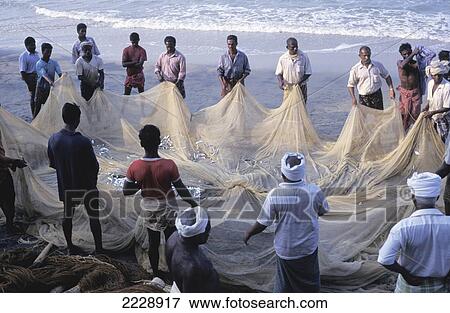 Stock Photo - Group Of Fishermen Working On Beach. Fotosearch