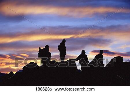 Stock Photography - Group Of Hikers Sillouetted On Mountain. Fotosearch