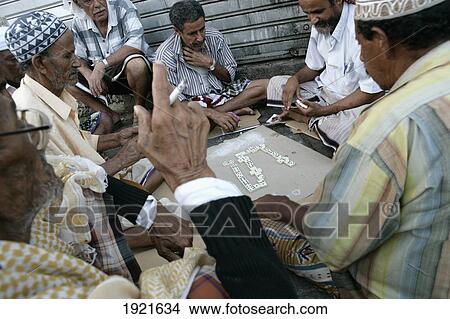 Picture - Group Of Men Playing Dominos. Fotosearch