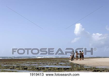 Stock Image - Group Of People On Beach, South Of Dar Es Salaam, Tanzania. Fotosearch