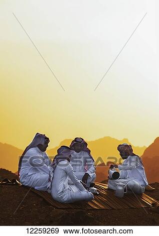 Stock Photo - Group of Saudis drinking tea on top of mountain range; Taif, Saudi Arabia. Fotosearch