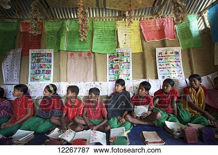Group of school children sitting along wall and learning; Sunamganj, Bangladesh View Large Photo Image Stock Photo - Group of school children sitting along wall and learning; Sunamganj, Bangladesh. Fotosearch