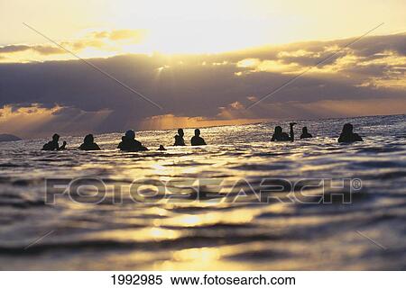 Stock Photography - Group Of Surfers Waiting For Waves At Sunset.. Fotosearch