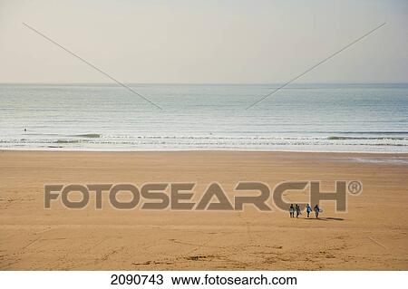 Group Of Surfers Walking On The Beach With Their Boards Towards The Sea In Putsborough Sands, North Devon, Uk View Large Photo Image Stock Image - Group Of Surfers Walking On The Beach With Their Boards Towards The Sea In Putsborough Sands, North Devon, Uk. Fotosearch