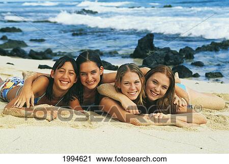Group Of Teenage Girls Laying On The Beach. View Large Photo Image Stock Image - Group Of Teenage Girls Laying On The Beach.. Fotosearch