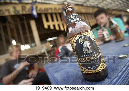 Stock Photo - Group Of Travelers Enjoying Beer In Roadside Bar, Tanzania. Fotosearch