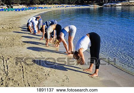 Group Of Women Performing Yoga On Beach View Large Photo Image Stock Photo - Group Of Women Performing Yoga On Beach. Fotosearch